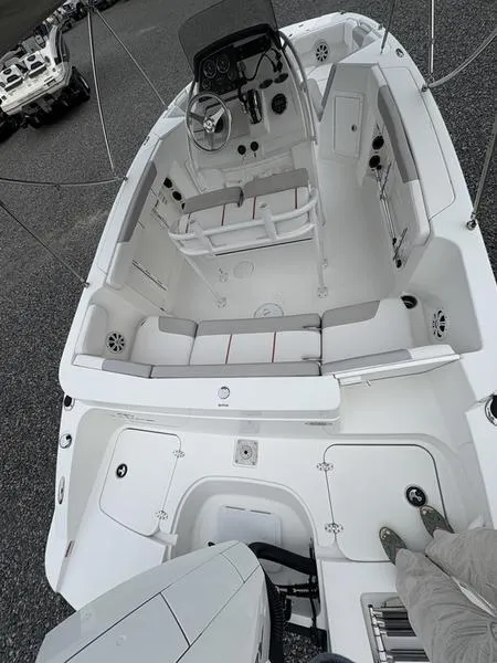 Slide: The Image of 2020 Tahoe 2150 boat interior with seating, steering console, and storage compartments. - 10