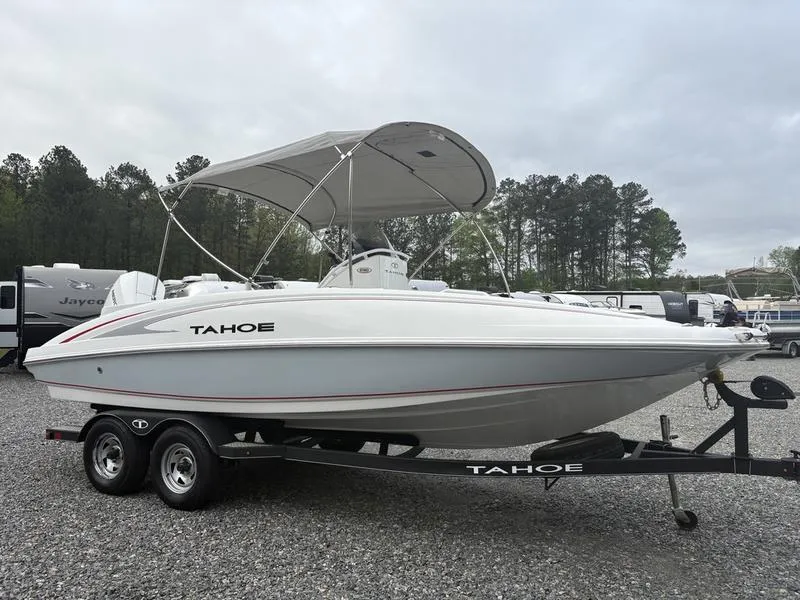 Slide: The Image of 2020 Tahoe 2150 boat on trailer with canopy, parked outdoors. - 4