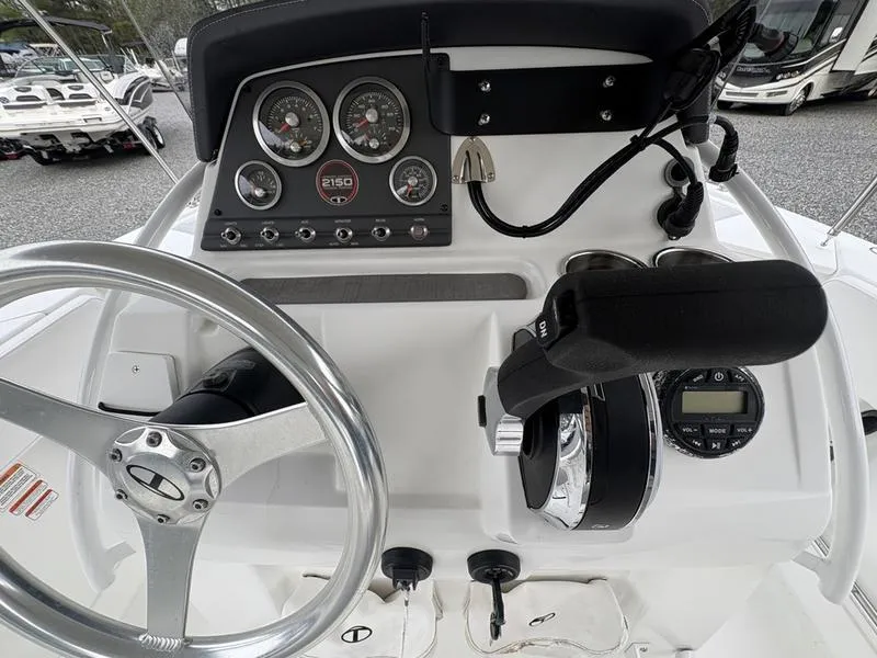 Slide: The Image of 2020 Tahoe 2150 boat dashboard with steering wheel and control panel. - 8