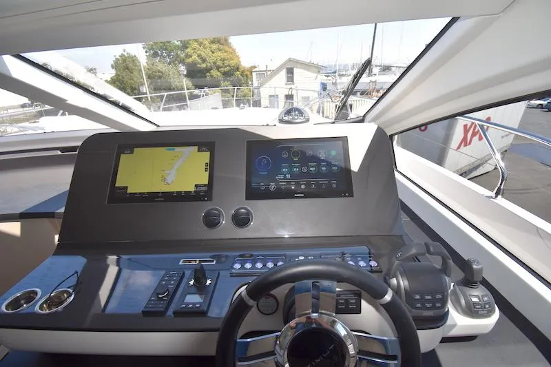 Slide: The Image of 2024 Azimut Fly 68 yacht cockpit with advanced navigation displays and controls. - 11