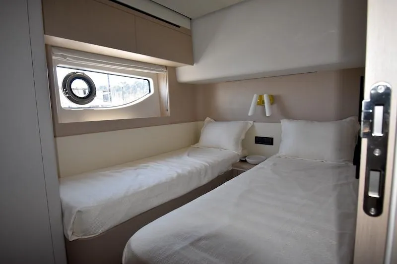 Slide: The Image of Luxurious cabin interior of 2024 Azimut Fly 68 yacht with twin beds and window. - 13