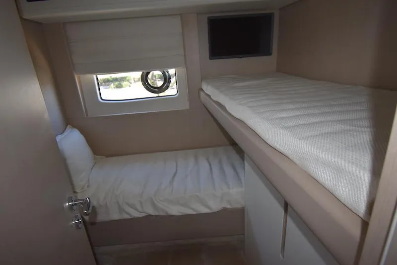 Slide: The Image of 2024 Azimut Fly 68 yacht cabin with bunk beds and window. - 14