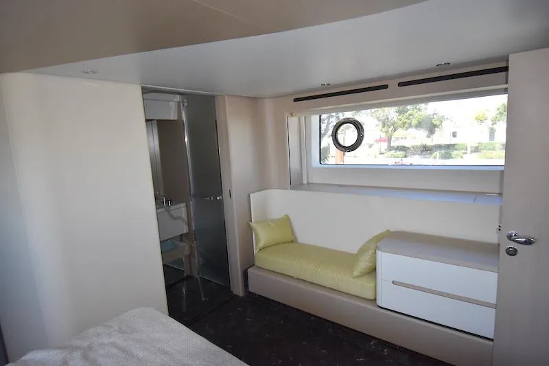 Slide: The Image of Interior of 2024 Azimut Fly 68 yacht, featuring a cozy cabin with a window and seating. - 17