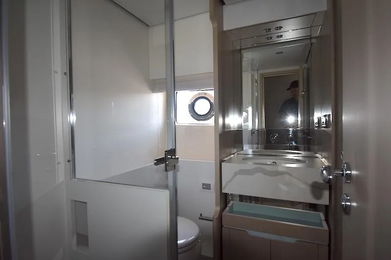 Slide: The Image of Luxurious bathroom in 2024 Azimut Fly 68 yacht with modern fixtures and porthole window. - 18