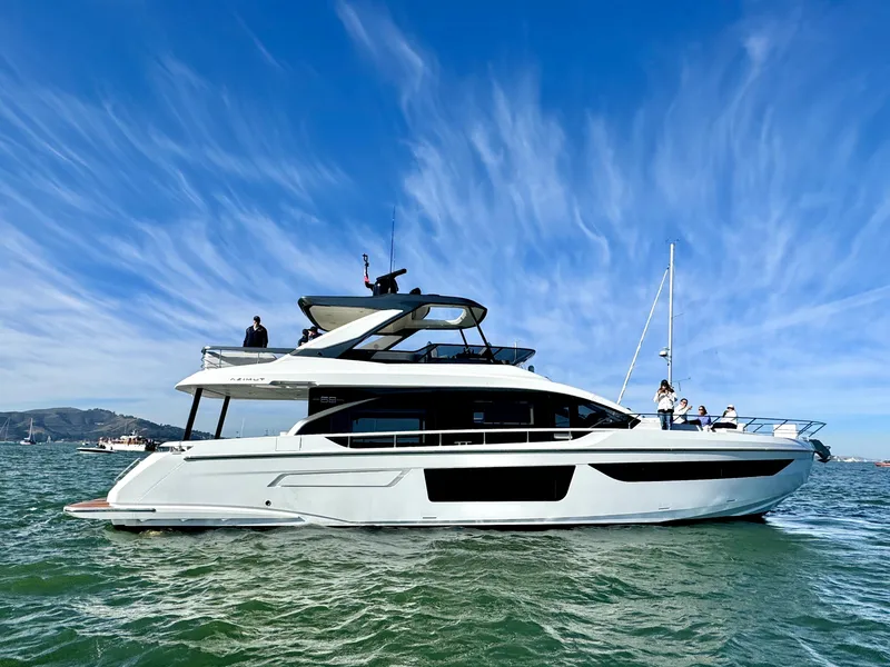 Slide: The Image of 2024 Azimut Fly 68 yacht cruising on open water under a clear blue sky. - 3