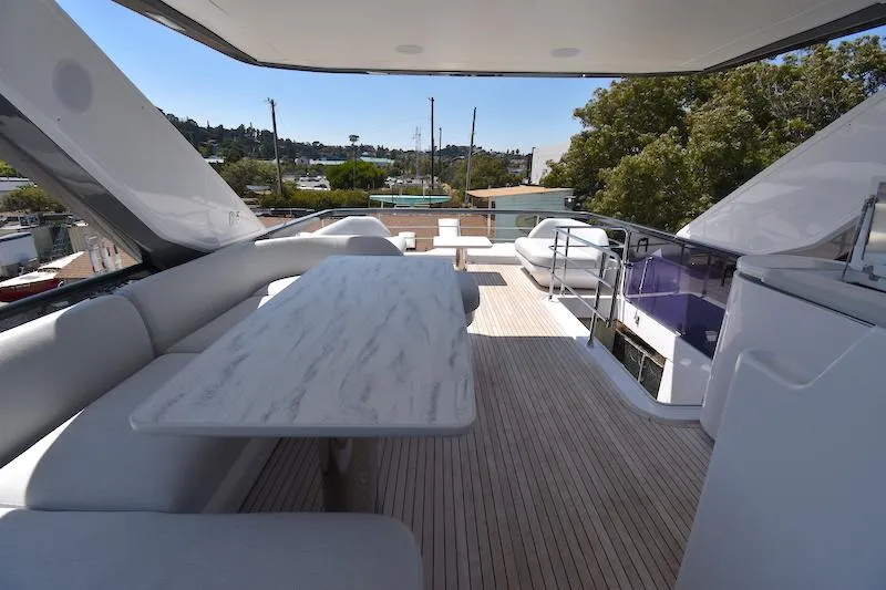 Slide: The Image of Luxurious 2024 Azimut Fly 68 yacht deck with elegant seating and dining area. - 32
