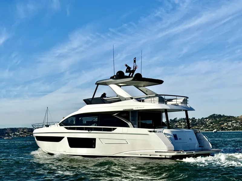 Slide: The Image of 2024 Azimut Fly 68 yacht cruising on open water under a clear blue sky. - 4