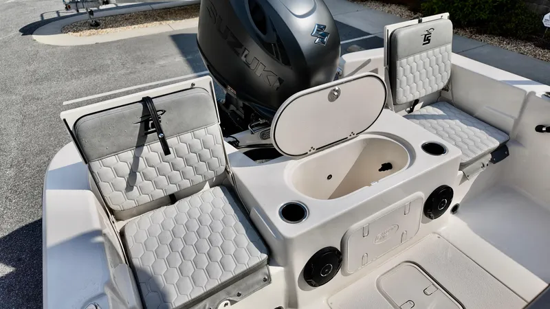 Slide: The Image of 2025 Carolina Skiff 21 LS Stealth Edition boat interior with seating and storage compartments. - 10