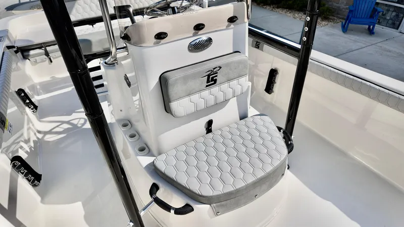 Slide: The Image of 2025 Carolina Skiff 21 LS Stealth Edition boat interior with cushioned seating and modern design. - 11