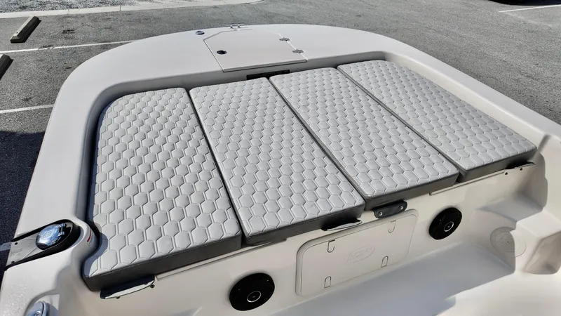 Slide: The Image of 2025 Carolina Skiff 21 LS Stealth Edition boat with cushioned seating and storage compartments. - 12