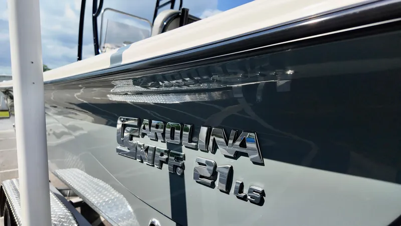 Slide: The Image of 2025 Carolina Skiff 21 LS Stealth Edition boat, close-up of logo and sleek design. - 4