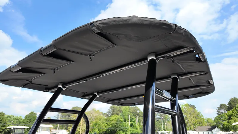 Slide: The Image of 2025 Carolina Skiff 21 LS Stealth Edition T-top against blue sky. - 7
