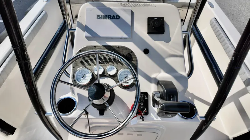 Slide: The Image of 2025 Carolina Skiff 21 LS Stealth Edition boat console with steering wheel and Simrad electronics. - 8