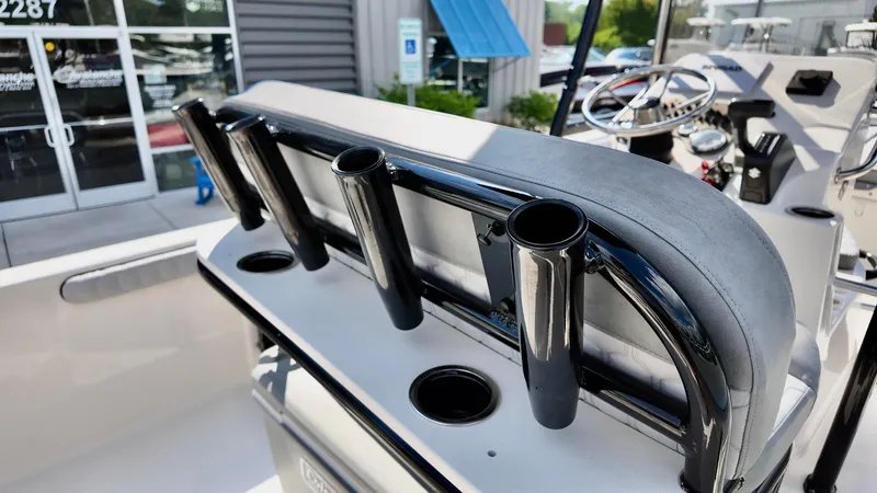 Slide: The Image of 2025 Carolina Skiff 21 LS Stealth Edition boat with rod holders and steering console. - 9
