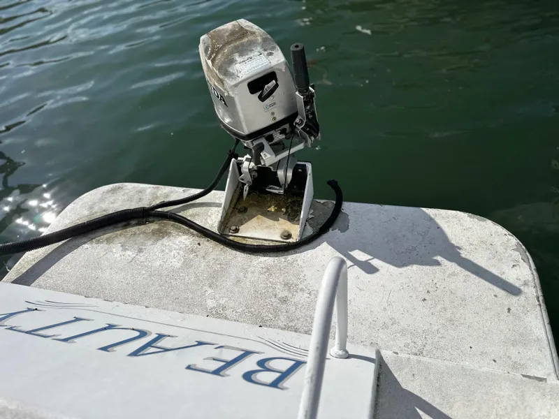 Slide: The Image of Outboard motor on ACB 23/26 Explorer boat, 2002 model, near water. - 10