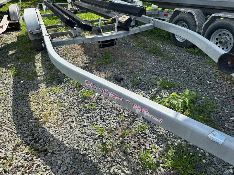Slide: The Image of Boat trailer for ACB 23/26 Explorer, 2002 model, on gravel with grass. - 12