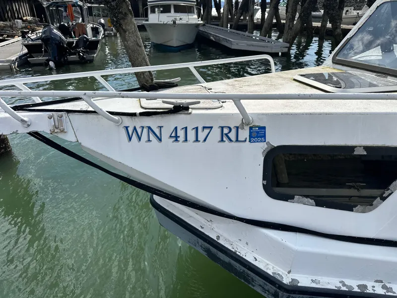 Slide: The Image of 2002 ACB 23/26 Explorer boat docked, registration WN 4117 RL, with 2025 sticker. - 2