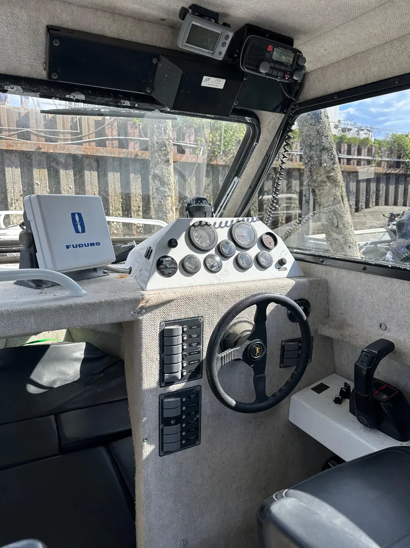 Slide: The Image of Interior of 2002 ACB 23/26 Explorer boat with steering wheel and control panel. - 4