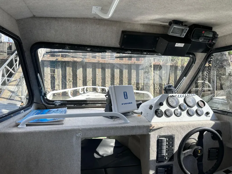 Slide: The Image of Interior of 2002 ACB 23/26 Explorer boat with navigation equipment and steering wheel. - 5