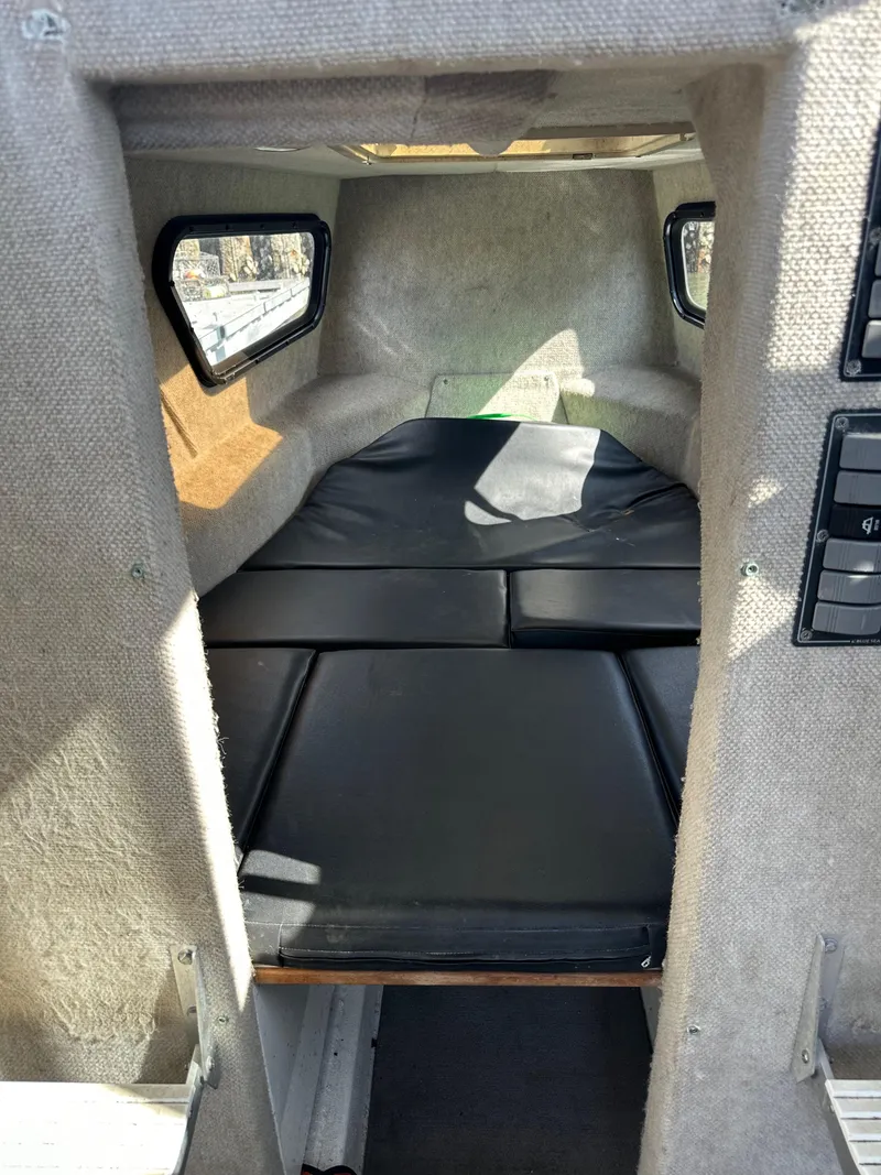 Slide: The Image of Interior cabin of 2002 ACB 23/26 Explorer boat with cushioned seating. - 6