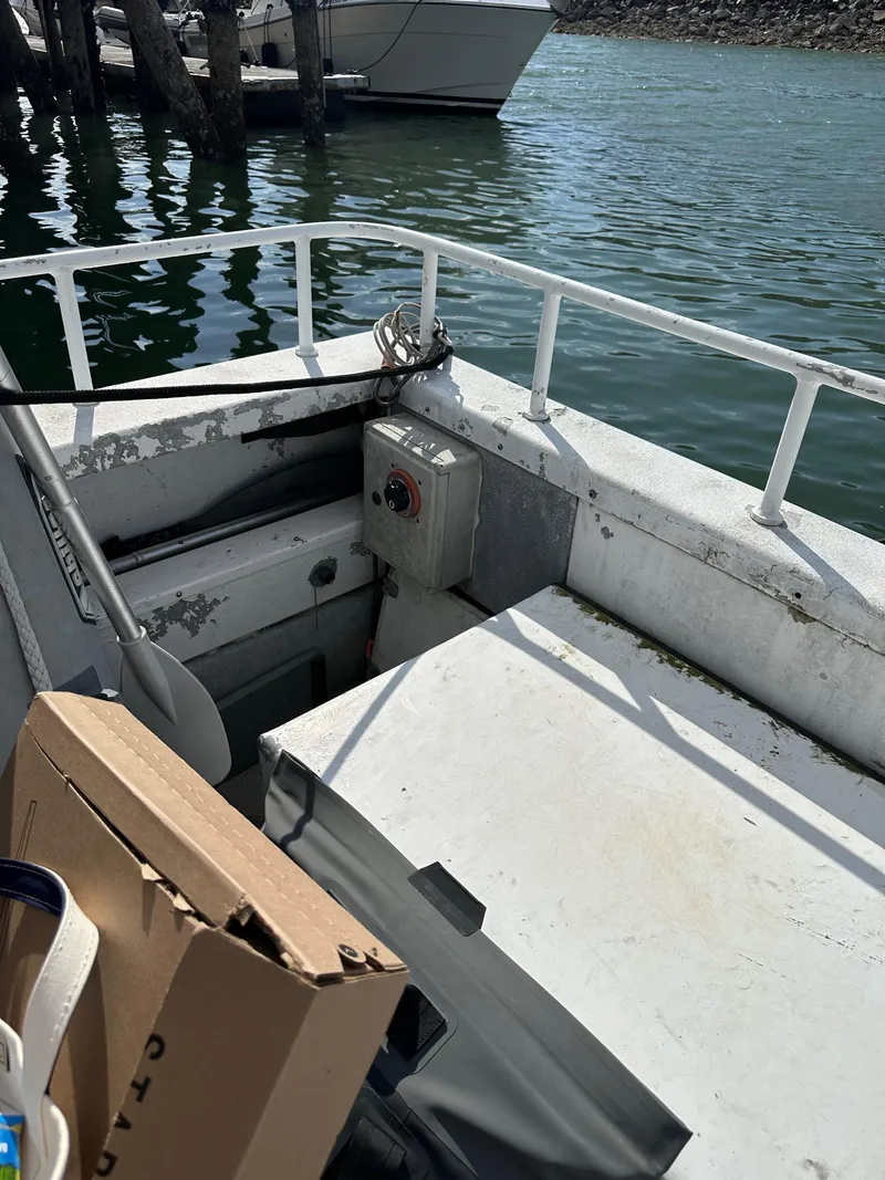 Slide: The Image of 2002 ACB 23/26 Explorer boat interior at dock, featuring seating and railing. - 9