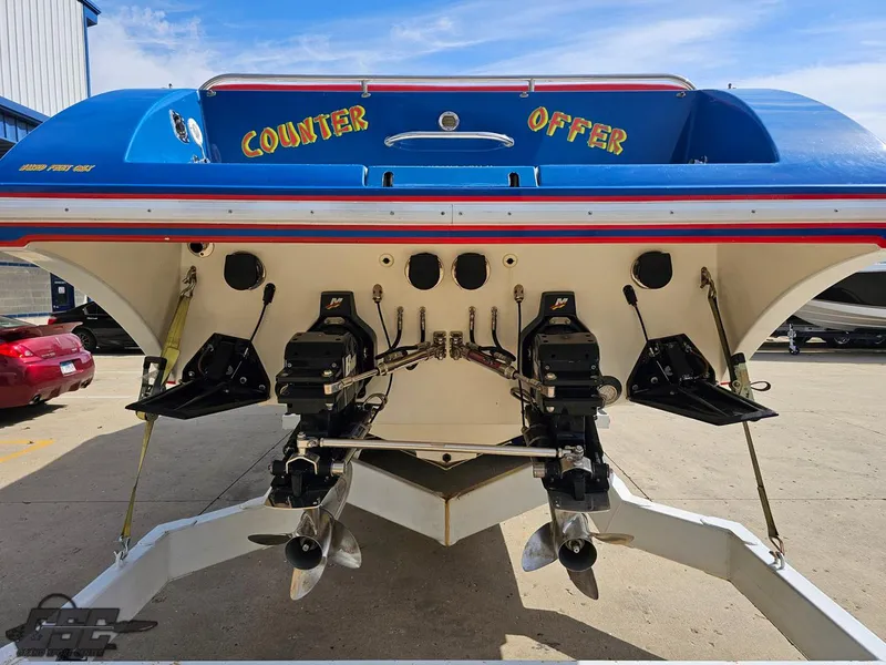 Slide: The Image of 2002 Black Thunder 460 SC boat, rear view with dual engines, "Counter Offer" text. - 26