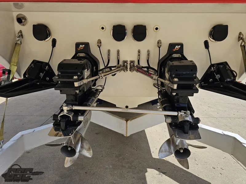 Slide: The Image of Rear view of 2002 Black Thunder 460 SC boat with dual propellers and outboard motors. - 27