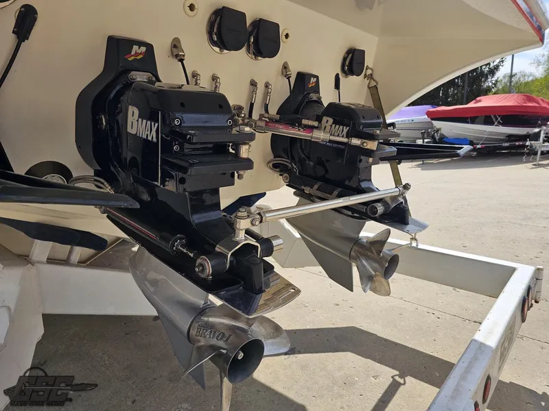 Slide: The Image of 2002 Black Thunder 460 SC boat with dual BMAX outdrives, docked on a sunny day. - 28