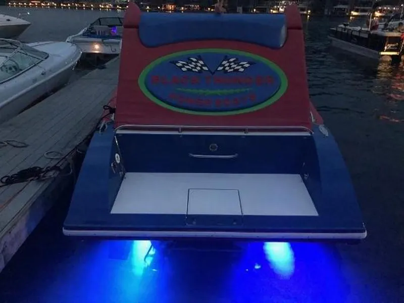Slide: The Image of 2002 Black Thunder 460 SC boat with blue underwater lights at dock. - 33