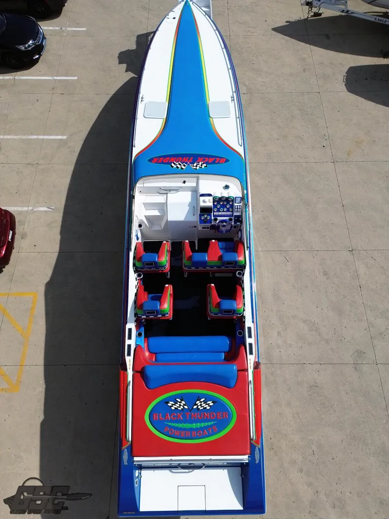 Slide: The Image of 2002 Black Thunder 460 SC powerboat, vibrant blue and red design, aerial view. - 34