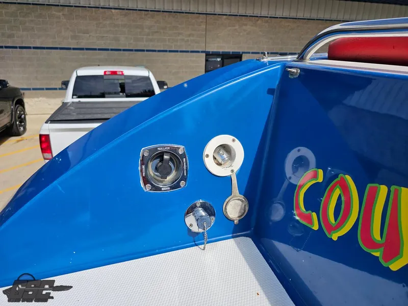 Slide: The Image of 2002 Black Thunder 460 SC boat detail with colorful graphics and fuel cap. - 38