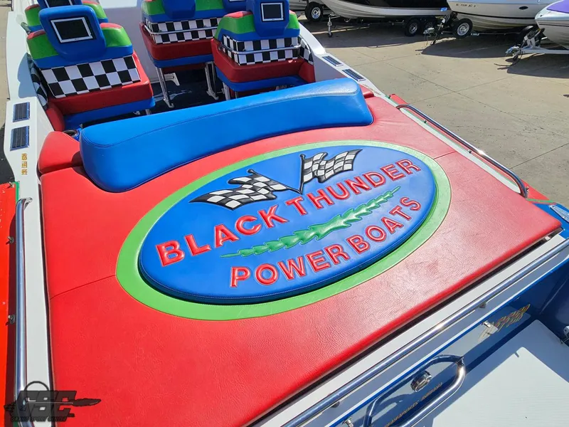 Slide: The Image of 2002 Black Thunder 460 SC powerboat with vibrant seating and logo design. - 40