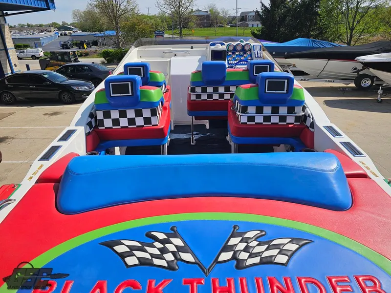 Slide: The Image of 2002 Black Thunder 460 SC boat interior with colorful seating and checkered patterns. - 42