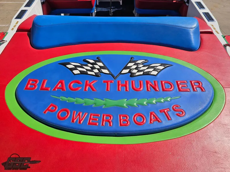 Slide: The Image of 2002 Black Thunder 460 SC power boat logo with vibrant colors and racing flags. - 43