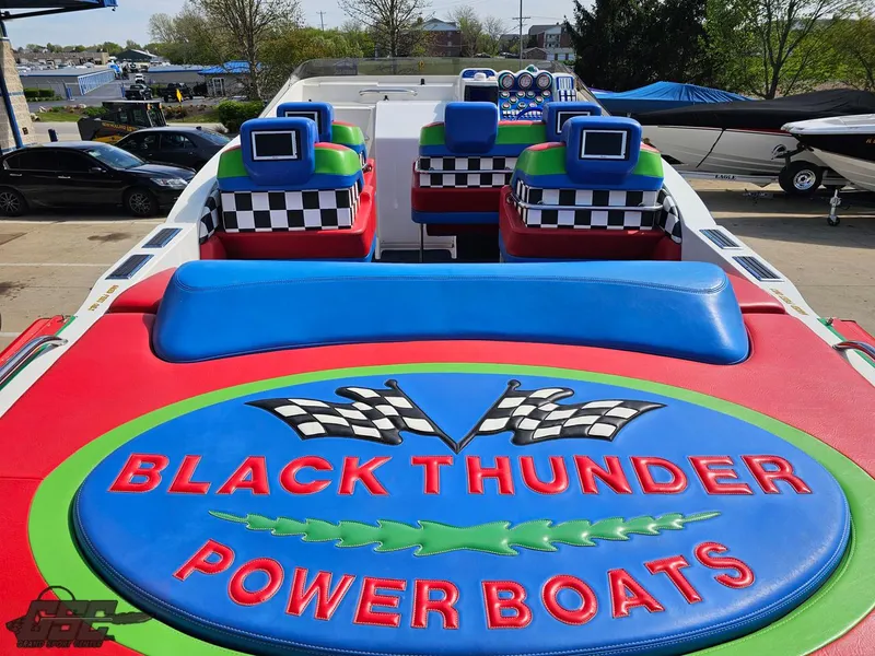 Slide: The Image of 2002 Black Thunder 460 SC power boat with colorful seating and logo design. - 45