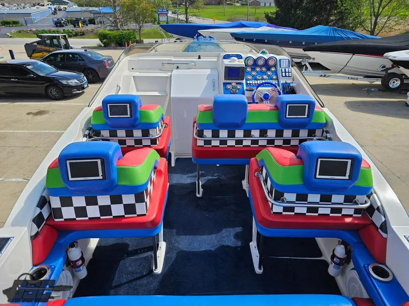 Slide: The Image of Colorful interior of a 2002 Black Thunder 460 SC boat with checkered seats and screens. - 46