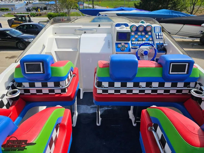 Slide: The Image of 2002 Black Thunder 460 SC boat interior with colorful seating and advanced dashboard controls. - 47