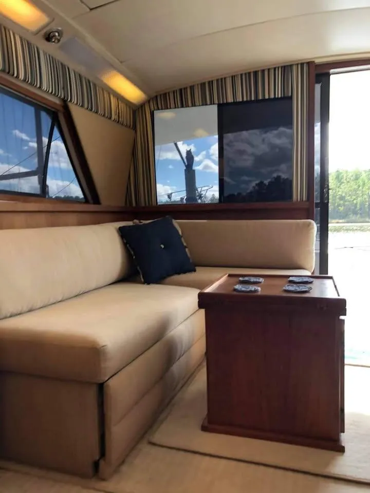 Slide: The Image of Interior of 1988 Bertram 37 Convertible yacht with beige sofa and wooden table. - 13