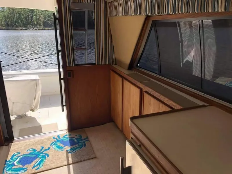 Slide: The Image of Interior of 1988 Bertram 37 Convertible yacht with striped decor and crab-themed rug. - 16