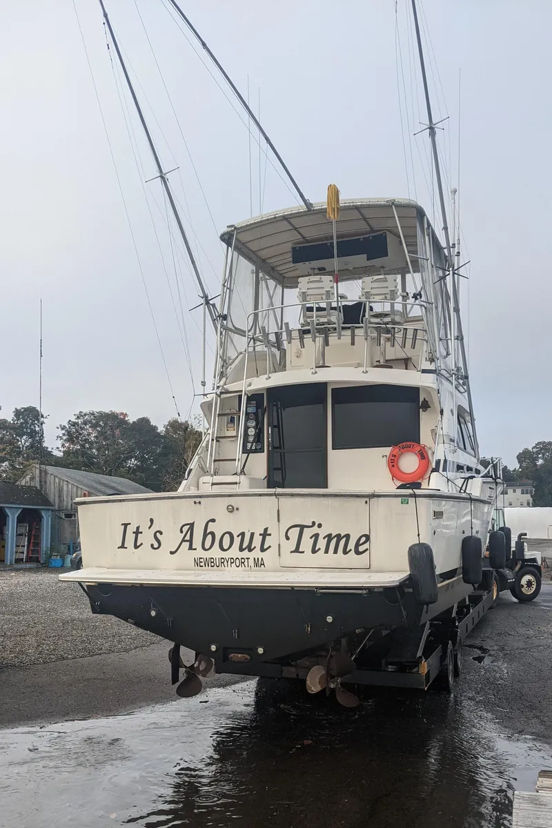 Slide: The Image of 1988 Bertram 37 Convertible boat named "It's About Time" on land, rear view. - 6
