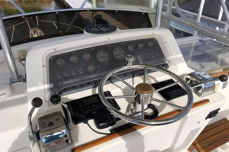 Slide: The Image of 1988 Bertram 37 Convertible boat helm with steering wheel and control panel. - 7