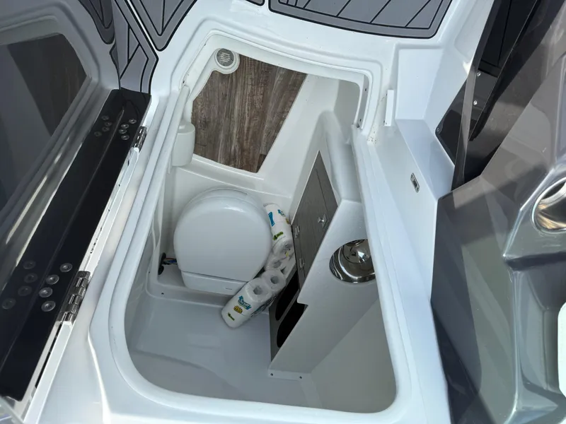 Slide: The Image of 2023 Monterey 258 Super Sport boat interior with compact bathroom amenities. - 10