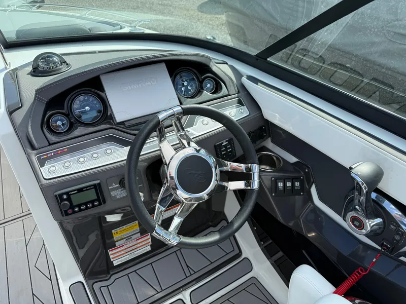 Slide: The Image of 2023 Monterey 258 Super Sport boat dashboard with steering wheel and controls. - 5