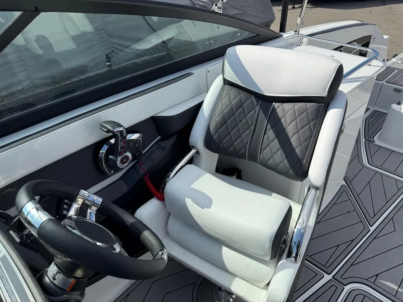 Slide: The Image of 2023 Monterey 258 Super Sport boat interior with sleek steering and cushioned seating. - 7