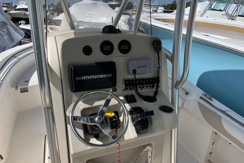 Slide: The Image of 2011 Pioneer 222 Sportfish boat console with steering wheel and navigation equipment. - 10