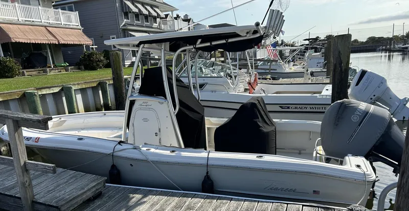 Slide: The Image of 2011 Pioneer 222 Sportfish boat docked at a marina, side view. - 13