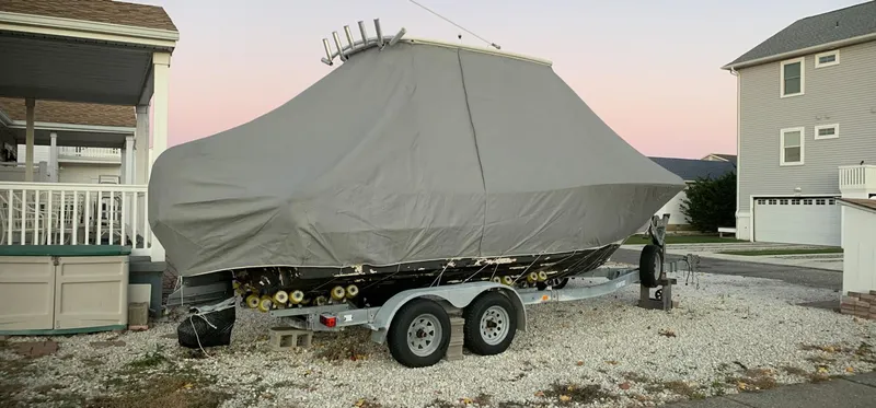 Slide: The Image of Covered 2011 Pioneer 222 Sportfish boat on trailer in residential area. - 14