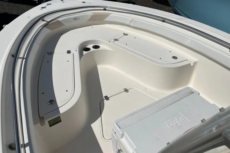 Slide: The Image of 2011 Pioneer 222 Sportfish boat interior with seating and storage compartments. - 7