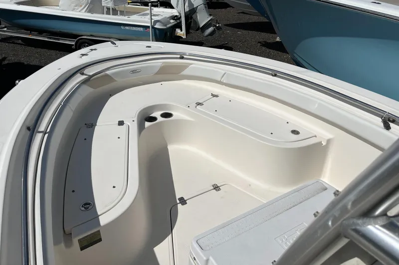 Slide: The Image of 2011 Pioneer 222 Sportfish boat interior with seating and storage compartments. - 8