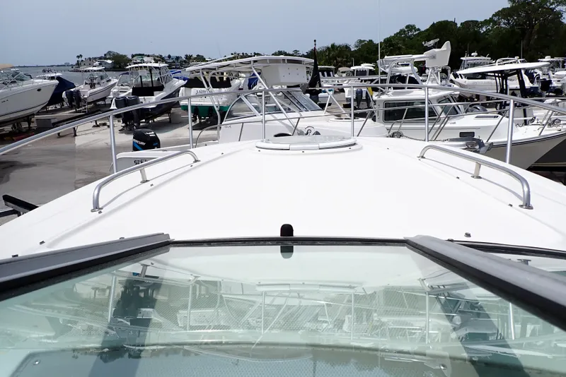 Slide: The Image of 2005 Monterey 270 Cruiser boat docked at a marina with multiple vessels. - 14